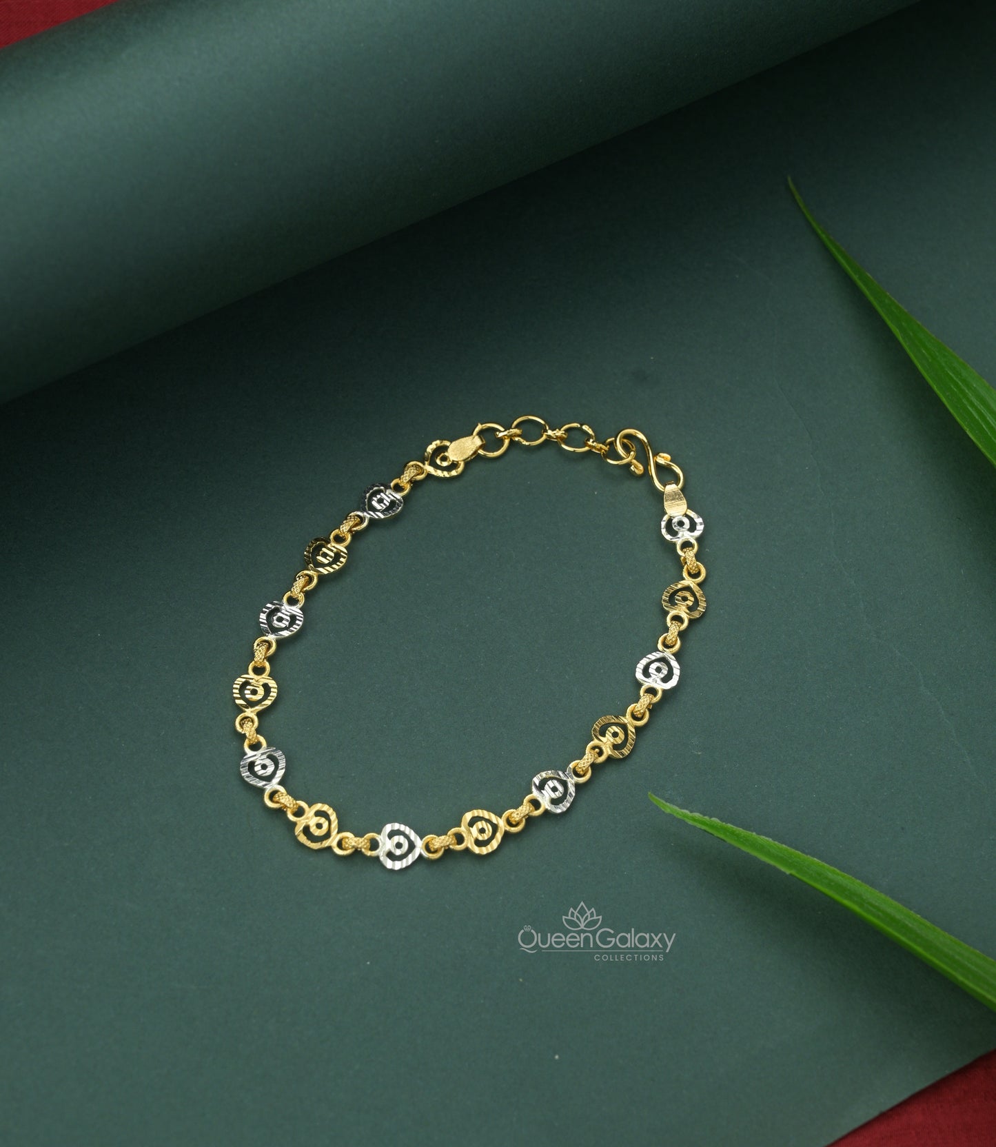 White Gold Plated Linked Heart Shaped Bracelet with a link chain design, displayed on a green background with a leaf accent.