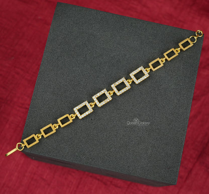Gold Plated AD Stone Square Bracelet for Women displayed on a black platform with a red background.