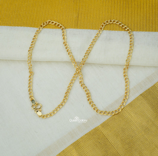 Gold plated link chain on Kerala kasavu saree background - queen galaxy collection