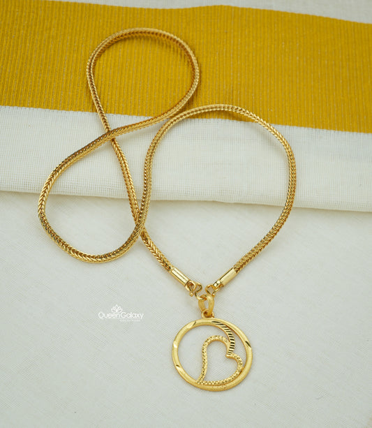 Gold plated chain with heart design pendant on cream and golden fabric background - queen galaxy collection