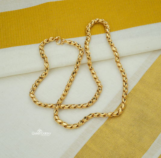 Gold plated twisted rope design chain on cream and golden fabric background - queen galaxy collection