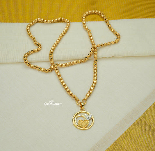 Gold plated bead chain with gold and silver dual heart pendant on cream fabric - queen galaxy collection