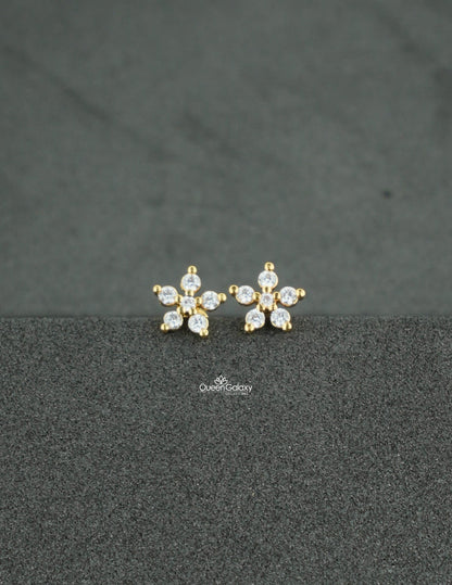 Gold plated AD stone floral nosepin and second stud on a dark textured background - queen galaxy collection