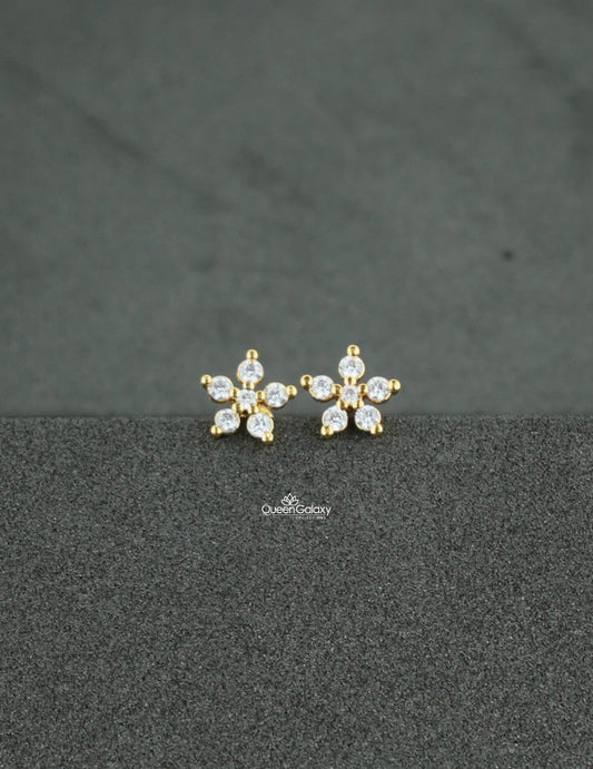 Gold plated AD stone floral nosepin and second stud on a dark textured background - queen galaxy collection