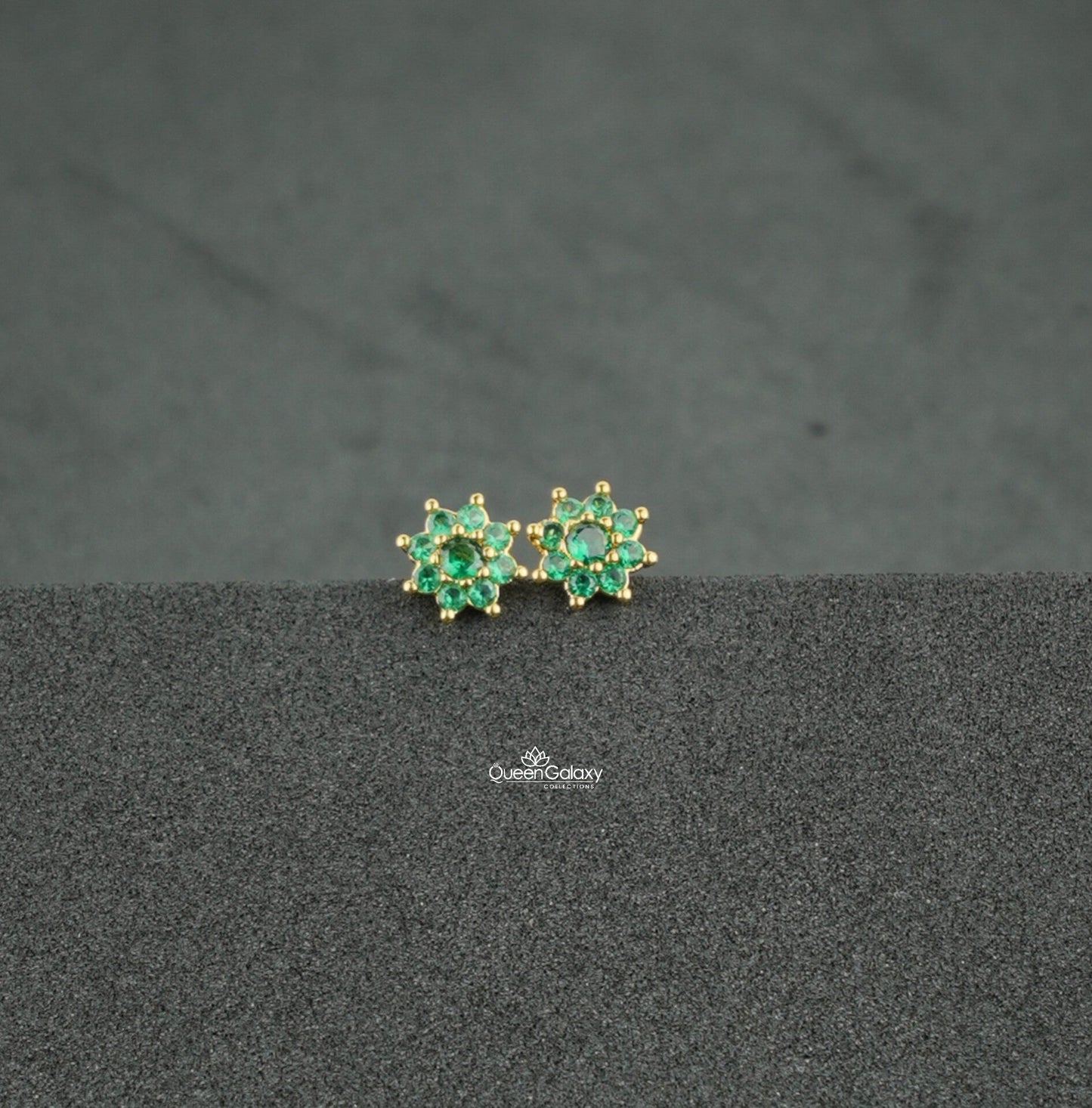 Gold plated green AD stone floral nosepin and second stud on dark background - queen galaxy collection