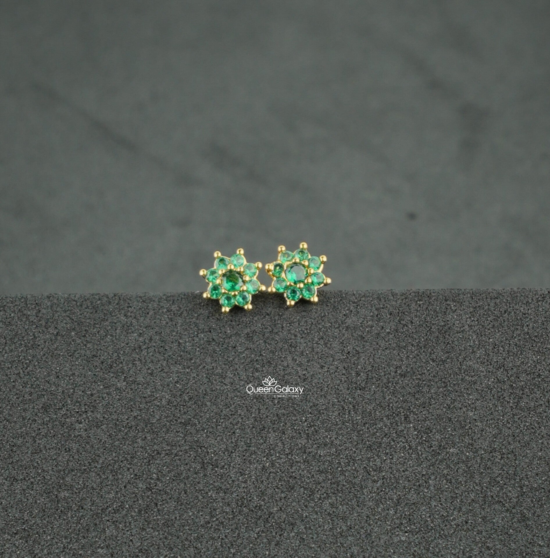 Gold plated green AD stone floral nosepin and second stud on dark background - queen galaxy collection
