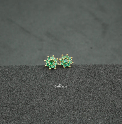 Gold plated green AD stone floral nosepin and second stud on dark background - queen galaxy collection