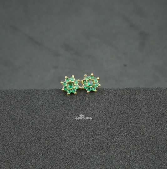 Gold plated green AD stone floral nosepin and second stud on dark background - queen galaxy collection