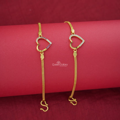 Two gold plated AD stone bracelets with heart designs on a red background, featuring the brand 'Queen Galaxy'.