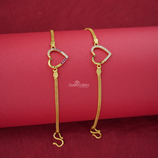 Two gold plated AD stone bracelets with heart designs on a red background, featuring the brand 'Queen Galaxy'.