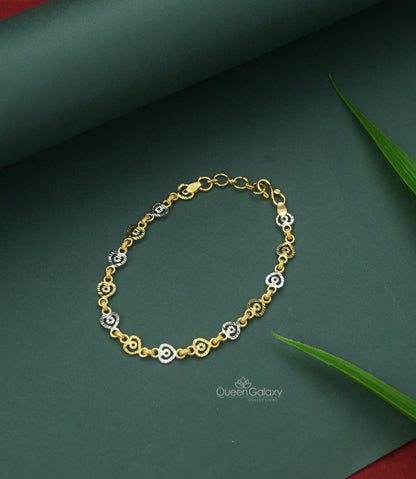 White Gold Plated Linked Heart Shaped Bracelet with a link chain design, displayed on a green background with a leaf accent.