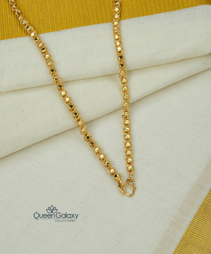Gold plated designer chain roll on a fabric background with Queen Galaxy logo.