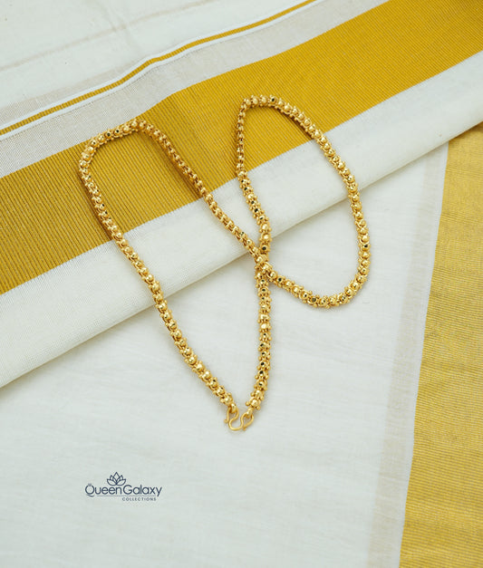 Gold plated traditional bead chain on Kerala kasavu saree background