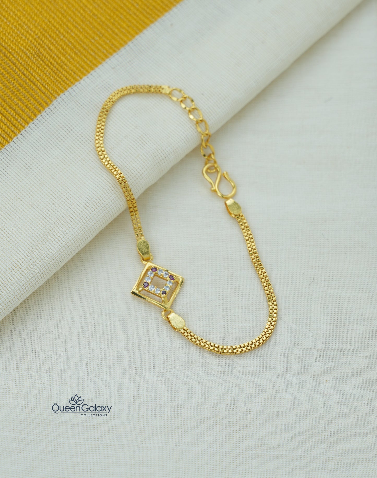 Gold Plated Purple & White AD Stone Bracelet with a square pendant on a light background